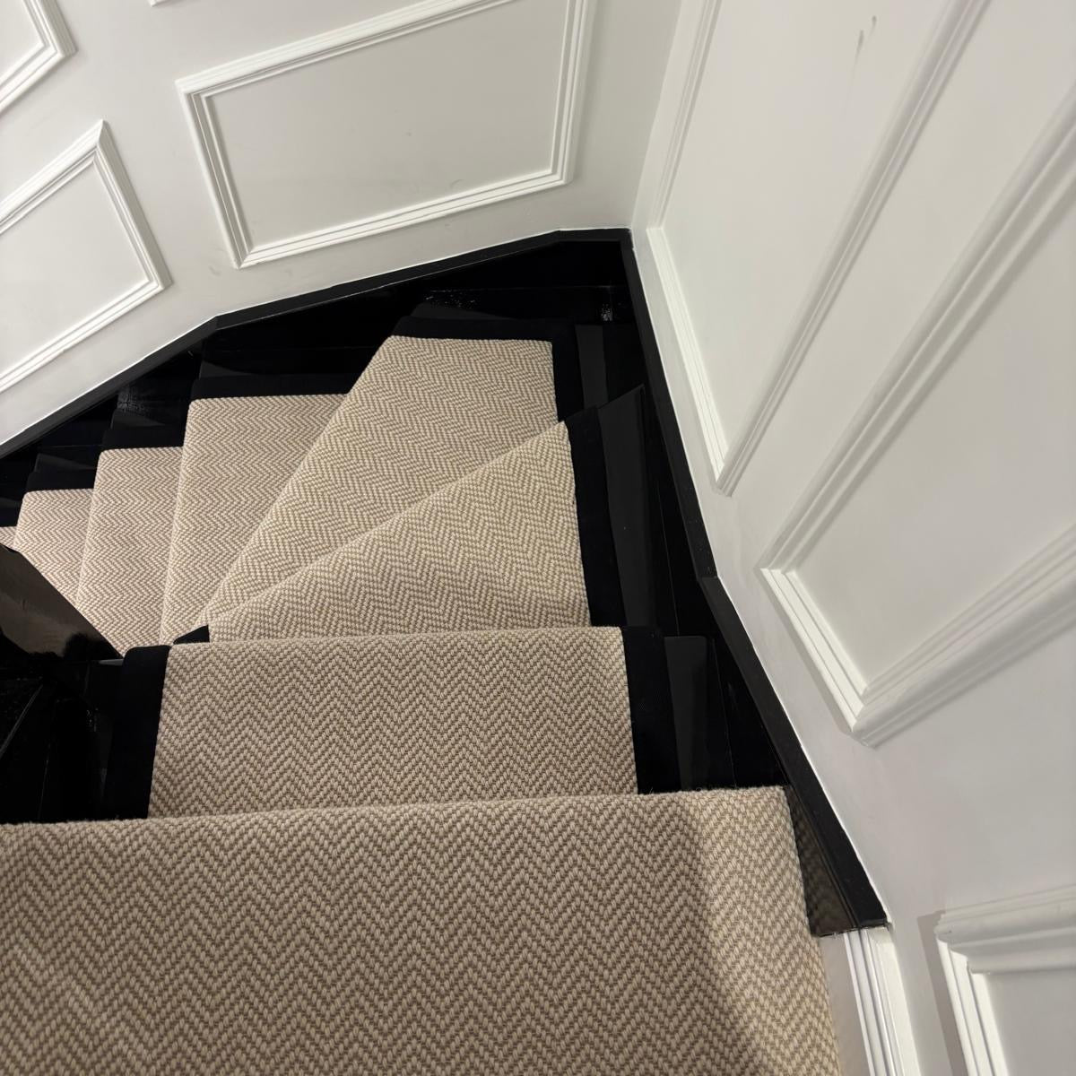 Herringbone bespoke runner fitted with black taping and stair rods luton london